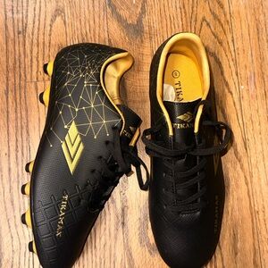 Tikan Black and Gold Soccer Cleats